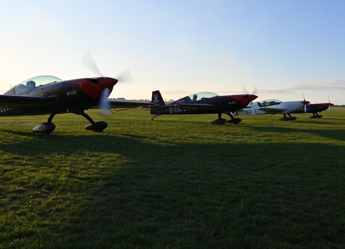 3 aircraft on grass
