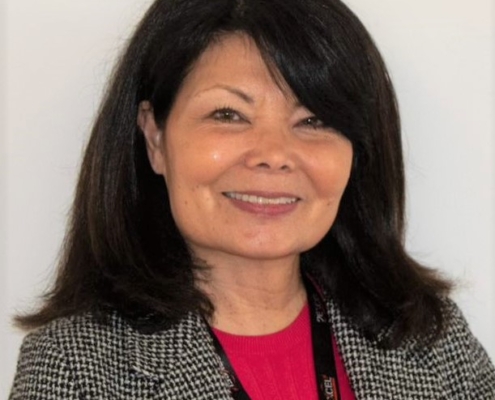 Cheri Bates wearing red top and grey jacket