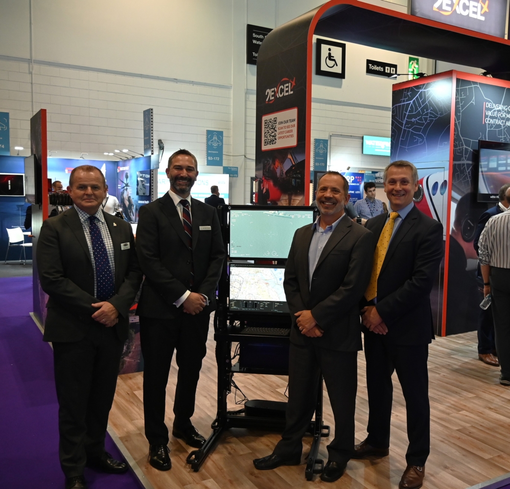 men standing with equipment on exhibition stand
