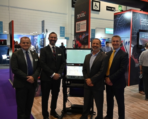 men standing with equipment on exhibition stand
