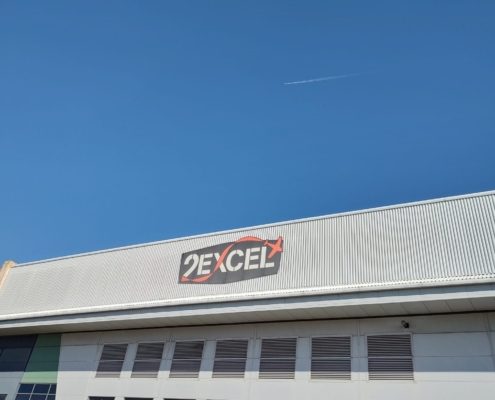 Building with company logo and blue sky