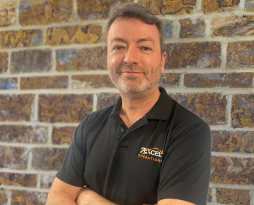 Simon Spurgeon arms folded against brick background