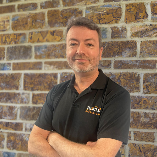 Simon Spurgeon arms folded against brick background